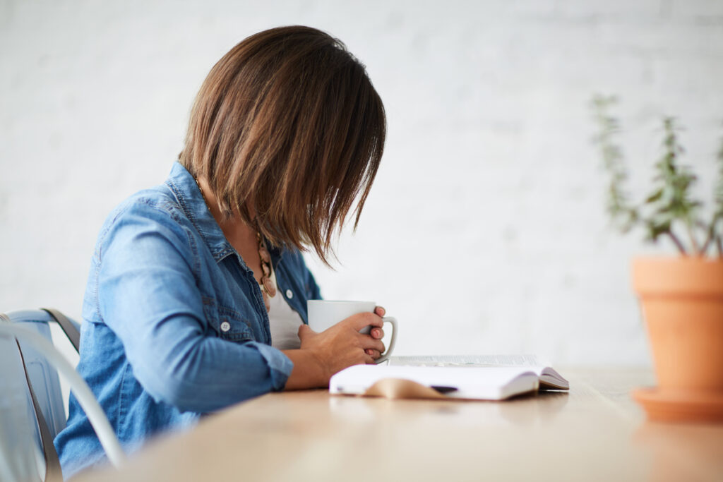 A Christian woman reading her Bible as a means to deepen her relationship with God.