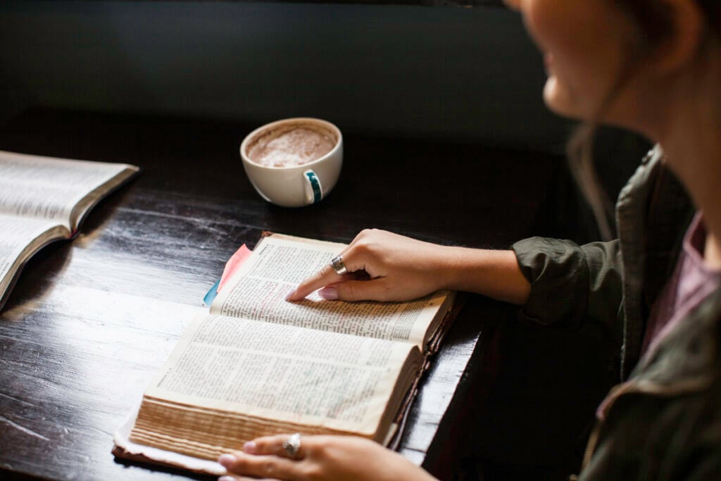 A Christian woman studying the Bible while enjoying a cup of hot chocolate