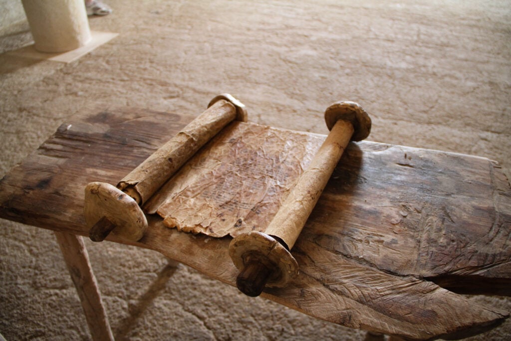 An ancient biblical scroll on a rusting table in the temple