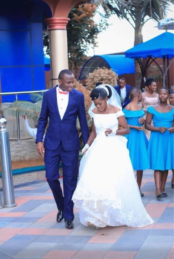 A Christian bride and groom leaving their wedding in Tanzania with smiles on their faces