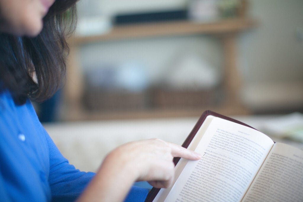 A Christian woman reading an open Bible