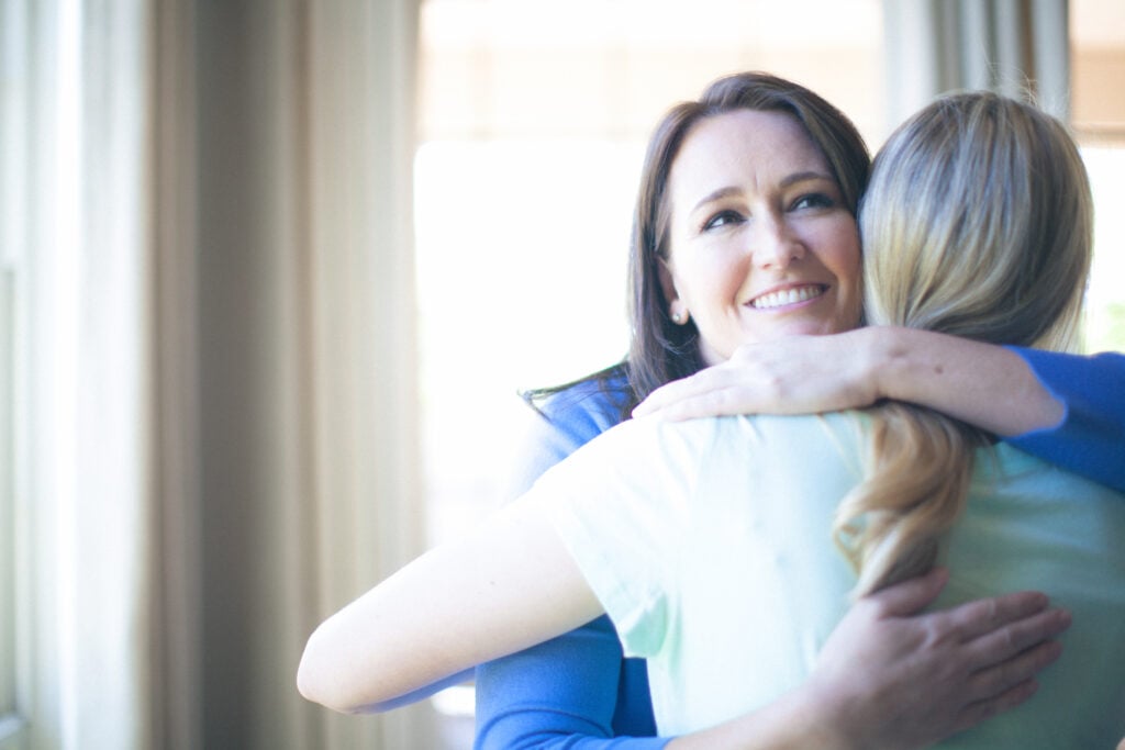 Two Christian women hugging
