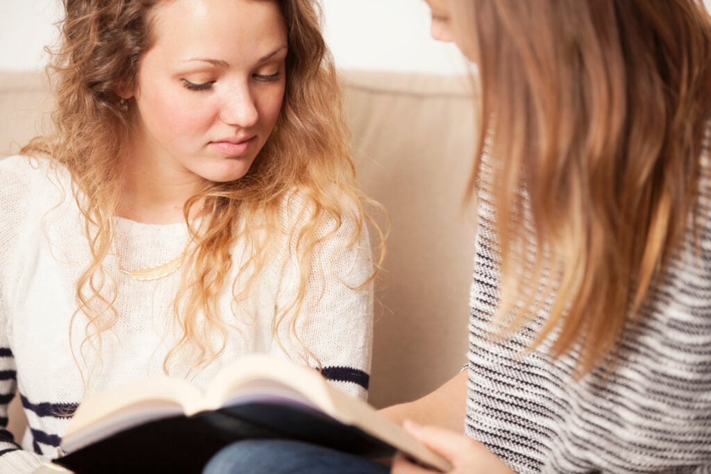 A young Christian woman learning about biblical kindness as her Christian mentor leads her in a Bible study about speaking the truth in love