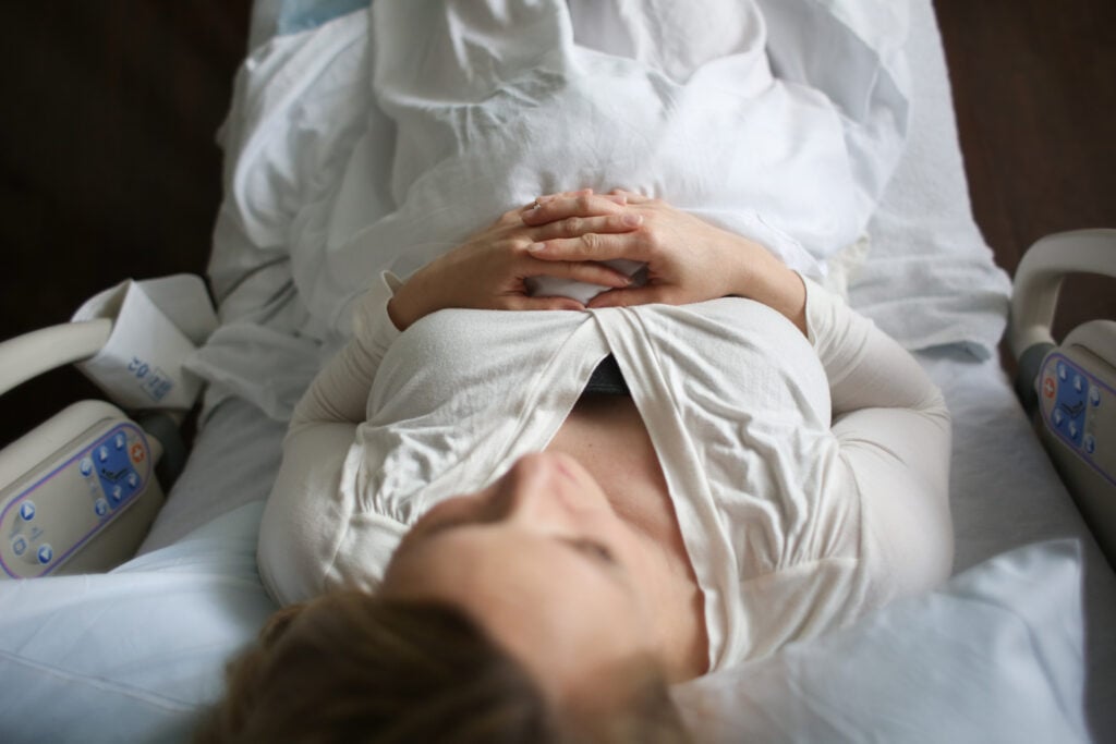 A Christian woman laying in a hospital bed and wondering about the goodness of God in difficult times