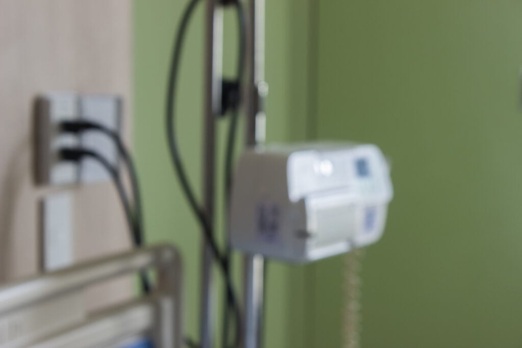 Medical equipment in a green and beige hospital room